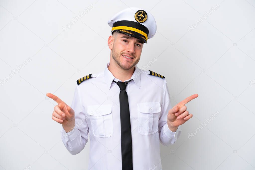 Airplane caucasian pilot isolated on white background pointing finger to the laterals and happy