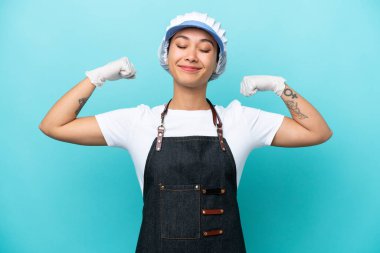 Arjantinli kadın mavi arka planda izole edilmiş güçlü bir jest yapıyor.