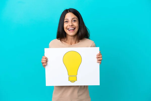 Young Woman Isolated Background Holding Placard Bulb Icon Happy Expression — Stock Photo, Image