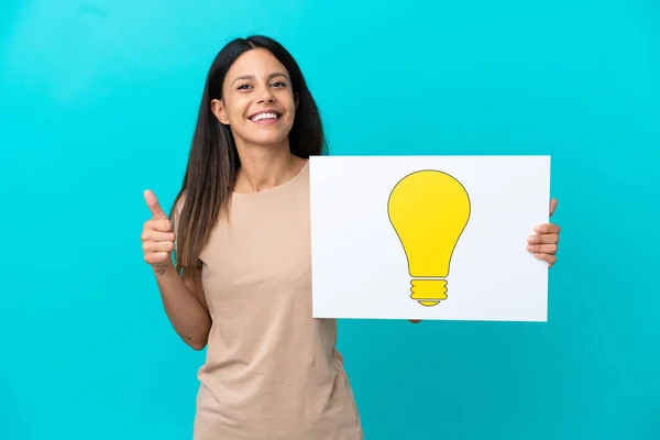Young Woman Isolated Background Holding Placard Bulb Icon Thumb — Zdjęcie stockowe