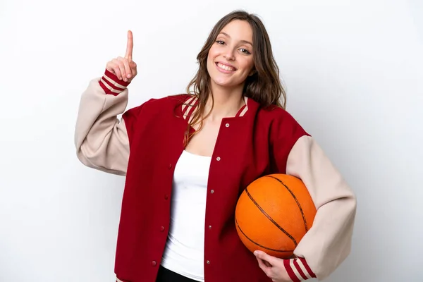 若いですCaucasian女性プレイバスケットボール孤立した上に白の背景ショーと持ち上げる指で最高の兆候 — ストック写真
