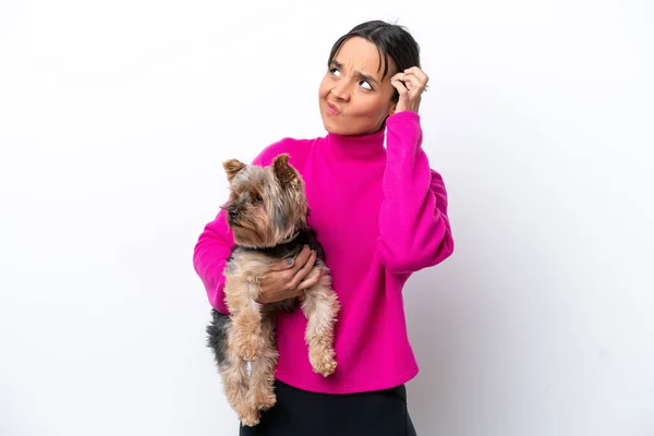 Young Hispanic Woman Holding Dog Isolated White Background Having Doubts — 스톡 사진