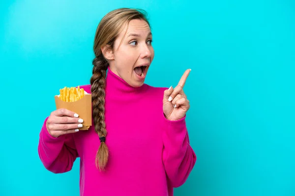 Young Caucasian Woman Holding Fried Chips Isolated Blue Background Intending — Stockfoto