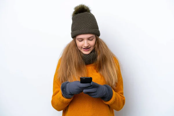 배경에 고립된 겨울용 자켓을 러시아 소녀가 휴대폰으로 메시지를 보내고 — 스톡 사진