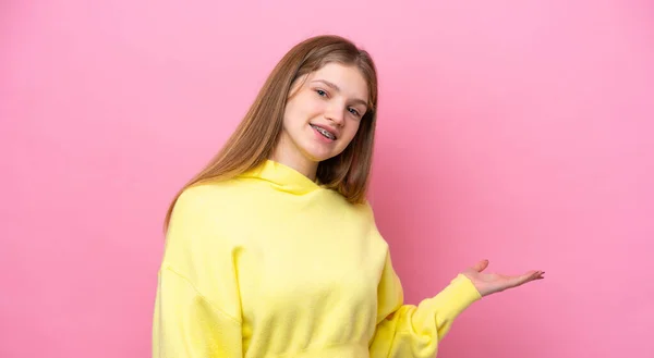 Adolescente Rusa Chica Aislado Rosa Fondo Extendiendo Las Manos Lado —  Fotos de Stock