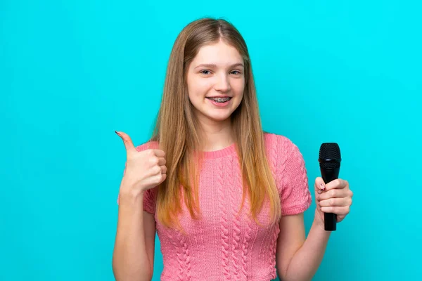 Singer Russian Girl Picking Microphone Isolated Blue Background Thumbs Because — Foto de Stock