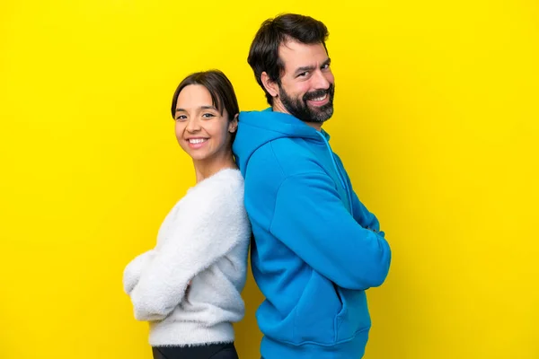 Young Caucasian Couple Isolated Yellow Background Keeping Arms Crossed — Stock fotografie