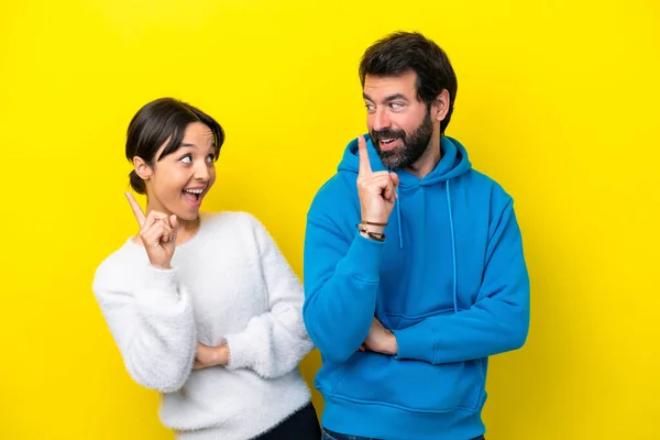 Young Caucasian Couple Isolated Yellow Background Intending Realizes Solution While — Foto Stock