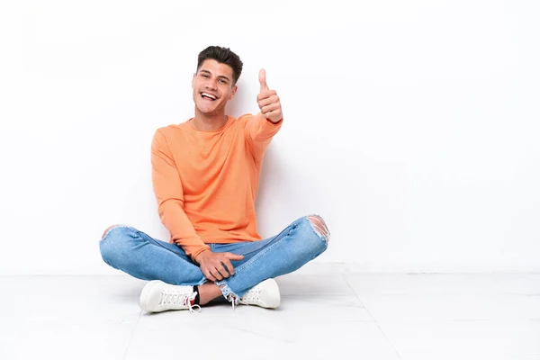 Young Man Sitting Floor Isolated White Background Thumbs Because Something — Stock Fotó