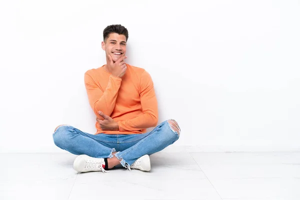 Young Man Sitting Floor Isolated White Background Smiling — Stok fotoğraf