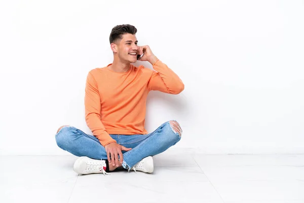 Young Man Sitting Floor Isolated White Background Keeping Conversation Mobile — Stok fotoğraf