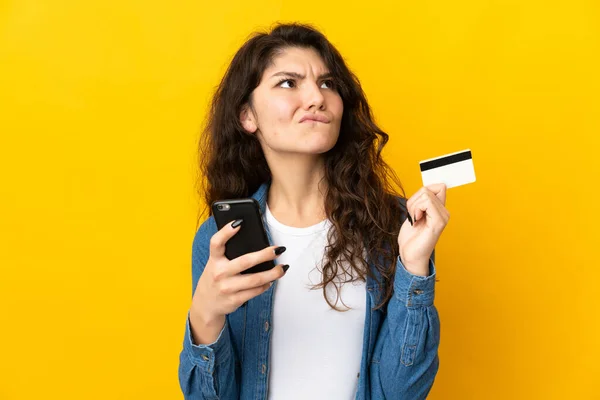 Teenager Russian Girl Isolated Yellow Background Buying Mobile Credit Card — Stock Photo, Image