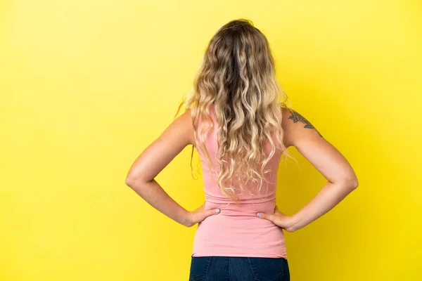 Young Brazilian Woman Isolated Yellow Background Back Position — 스톡 사진
