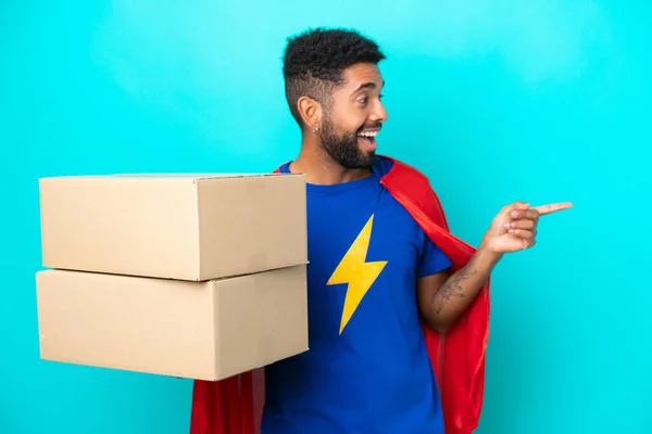 Super Hero Delivery Brazilian Man Isolated Blue Background Pointing Finger — Stock Photo, Image