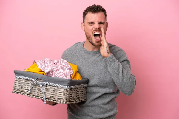 Young Brazilian Man Holding Clothes Basket Isolated Pink Background Shouting — Stok fotoğraf