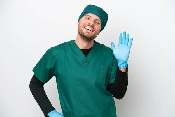 Surgeon Brazilian Man Green Uniform Isolated White Background Saluting Hand — Stockfoto