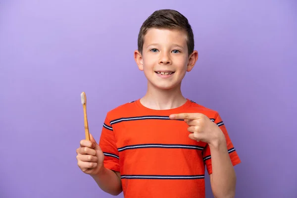 Little Boy Brushing Teeth Isolated Purple Background Pointing — ストック写真