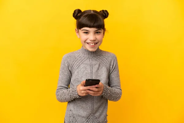 Little Caucasian Girl Isolated Yellow Background Sending Message Mobile — Stock Photo, Image