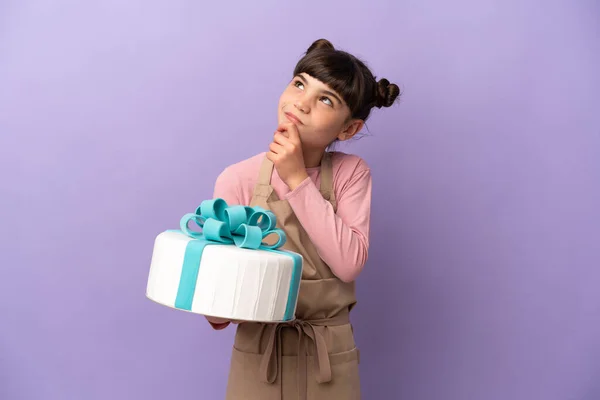 Pasticceria Bambina Possesso Una Grande Torta Isolata Sfondo Viola Guardando — Foto Stock