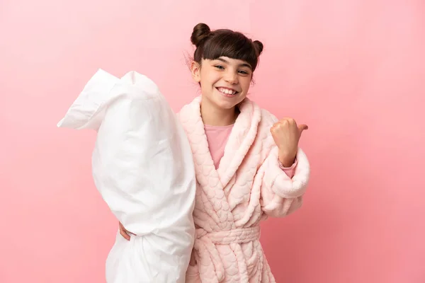 Little Caucasian Girl Isolated Pink Background Pajamas Pointing Side Present — Stock Photo, Image