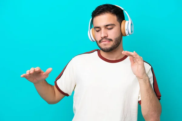 Young Brazilian Man Isolated Blue Background Listening Music Dancing — Stock Photo, Image