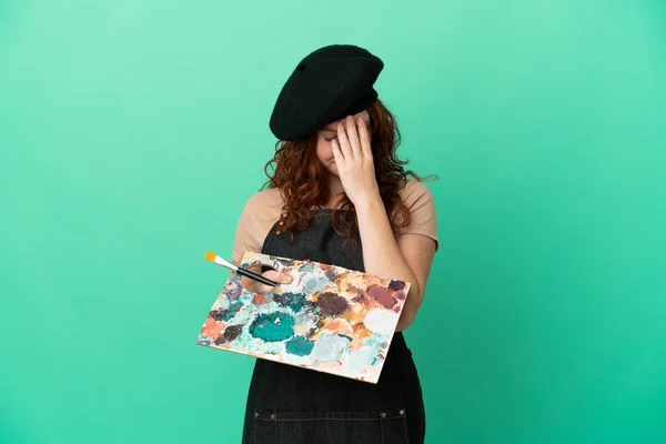 Teenager Redhead Artist Holding Palette Isolated Green Background Tired Sick — ストック写真