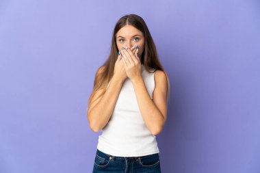 Young Lithuanian woman isolated on purple background covering mouth with hands