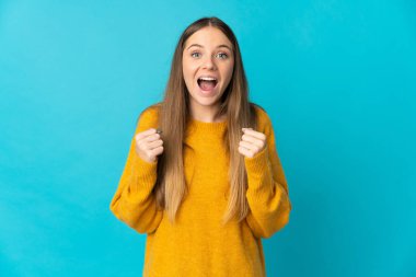 Genç Litvanyalı kadın mavi arka planda tek başına zaferi kutluyor.