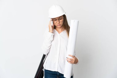 Young Lithuanian architect woman with helmet and holding blueprints isolated on white background with headache