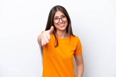 Beyaz arka planda izole edilmiş genç beyaz kadın iyi bir anlaşma için el sıkışıyor.