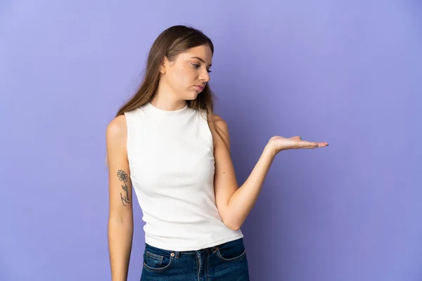 Young Lithuanian Woman Isolated Purple Background Holding Copyspace Doubts — стоковое фото
