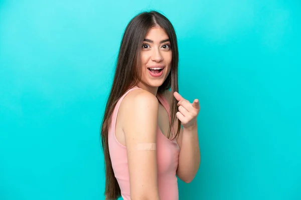 Young Caucasian Woman Band Aids Isolated Blue Background Surprised Pointing — стоковое фото