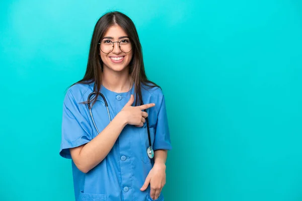 Young Nurse Caucasian Woman Isolated Blue Background Pointing Side Present — Stok fotoğraf