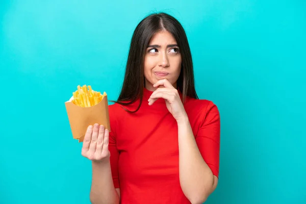 Young Caucasian Woman Catching French Fries Isolated Blue Background Having — стоковое фото