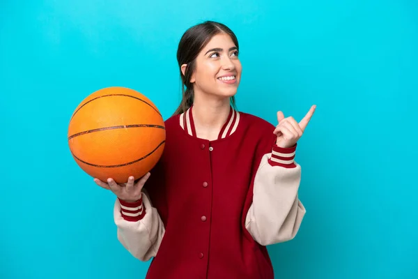 Young Caucasian Basketball Player Woman Isolated Blue Background Pointing Great — стоковое фото