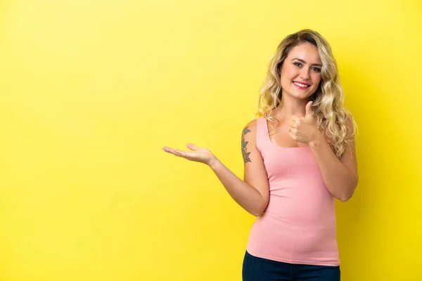 Young Brazilian Woman Isolated Yellow Background Holding Copyspace Imaginary Palm — Stock fotografie