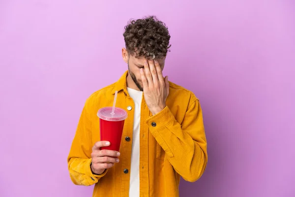 Young Blonde Man Holding Soda Isolated Purple Background Tired Sick — 스톡 사진