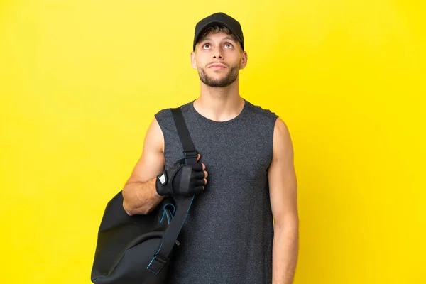 Young Sport Blonde Man Sport Bag Isolated Yellow Background Looking — Foto Stock