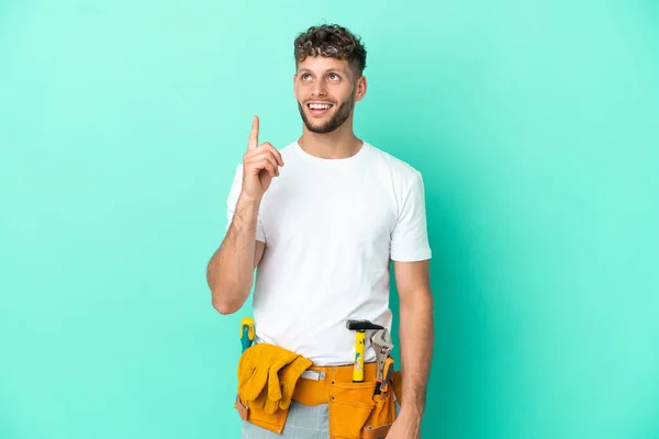 Young Electrician Blonde Man Isolated Green Background Pointing Surprised — Φωτογραφία Αρχείου