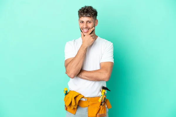 Young Electrician Blonde Man Isolated Green Background Smiling — Φωτογραφία Αρχείου