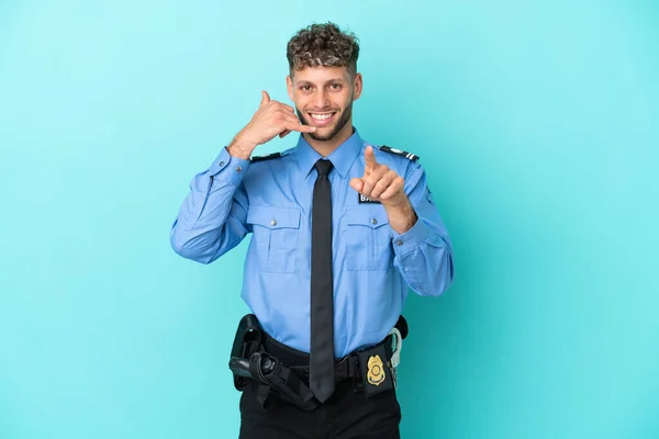 Young police blonde man isolated white on blue background making phone gesture and pointing front