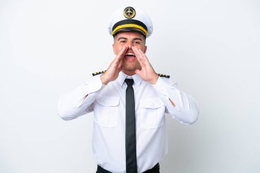 Airplane pilot caucasian man isolated on white background shouting and announcing something