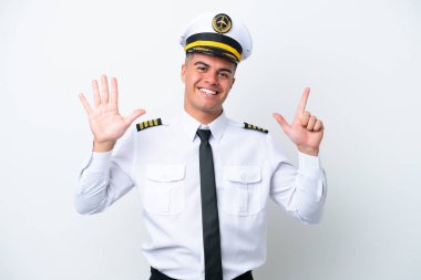 Airplane pilot caucasian man isolated on white background counting seven with fingers