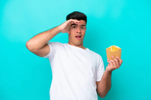 Young Caucasian Man Catching French Fries Isolated Blue Background Doing — Stockfoto