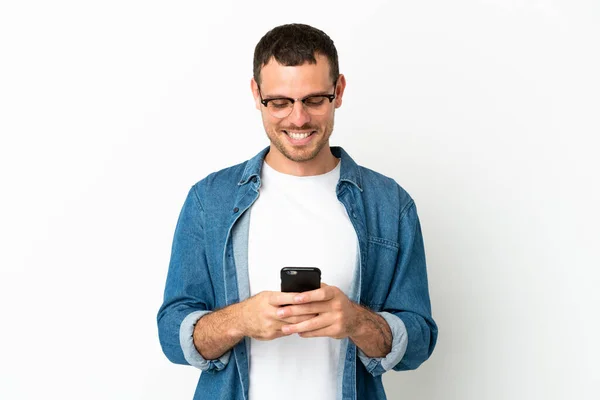 Brazilian Man Isolated White Background Sending Message Mobile — Zdjęcie stockowe