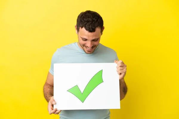 Brazilian Man Isolated Purple Background Holding Placard Text Green Check — ストック写真