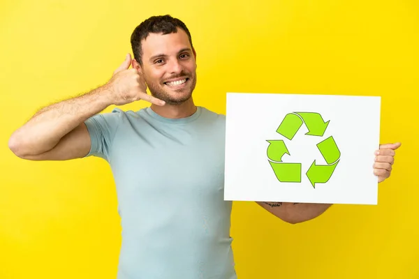 Brazilian Man Isolated Purple Background Holding Placard Recycle Icon Doing — Foto de Stock