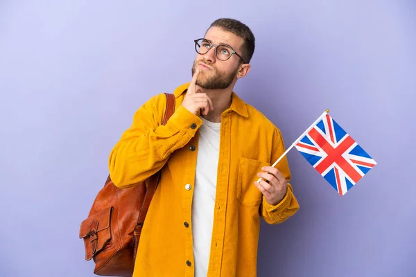 Young Caucasian Man Holding United Kingdom Flag Isolated Purple Background — Foto de Stock