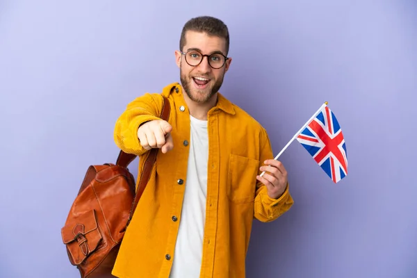 Young Caucasian Man Holding United Kingdom Flag Isolated Purple Background — стоковое фото