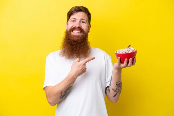 Redhead Man Beard Eating Bowl Cereals Isolated Yellow Background Pointing — Foto de Stock